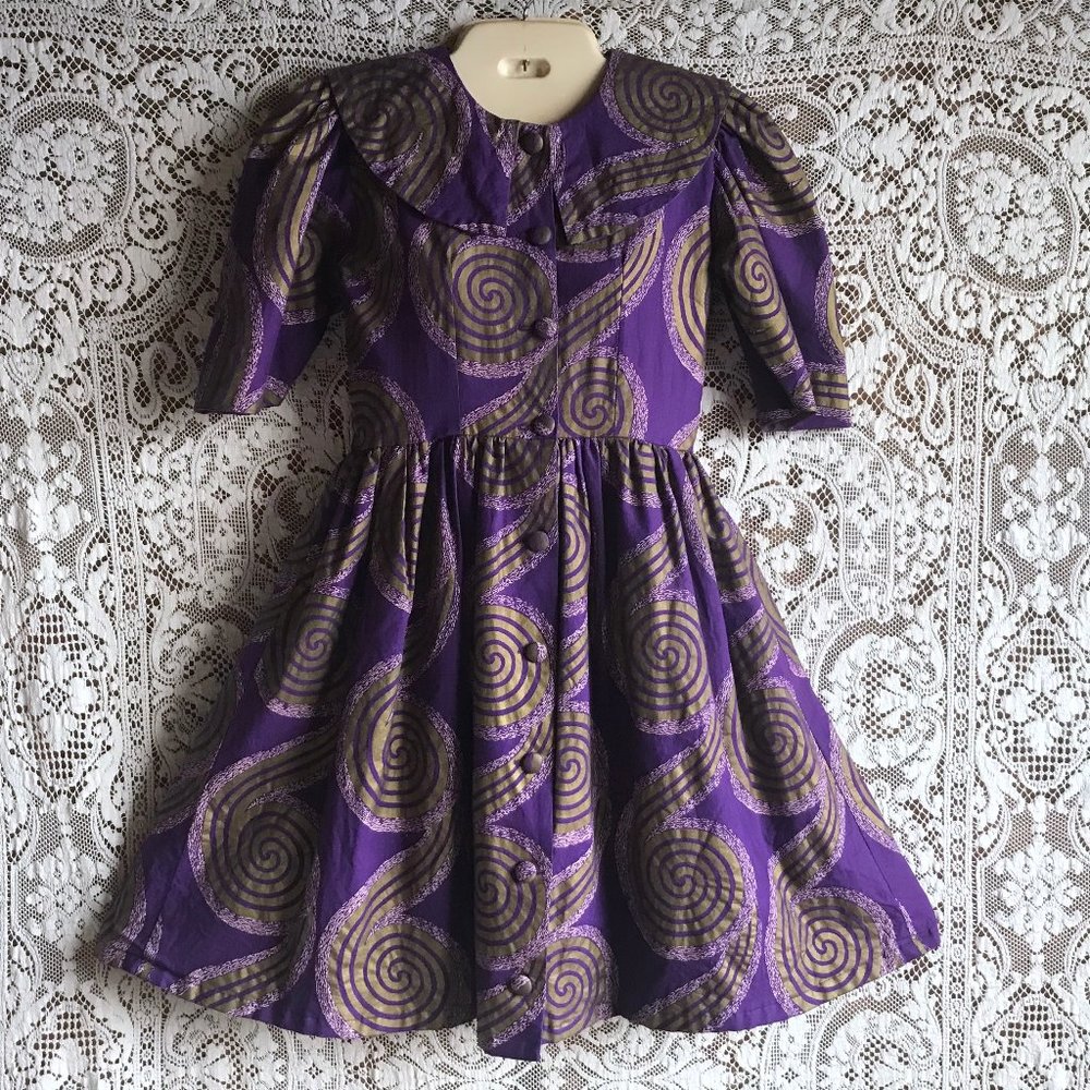 Vintage-Inspired Purple Mini Dress with Gold Swirl Detail